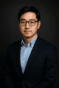 Daniel Kim in a navy blazer against a dark background